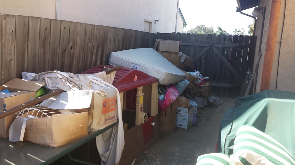 Yard piled with debris before haul